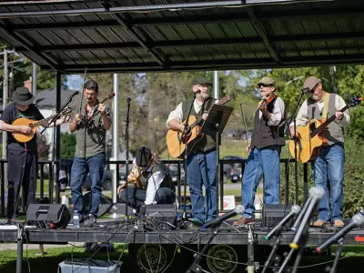 A band performs on an outdoor stage.