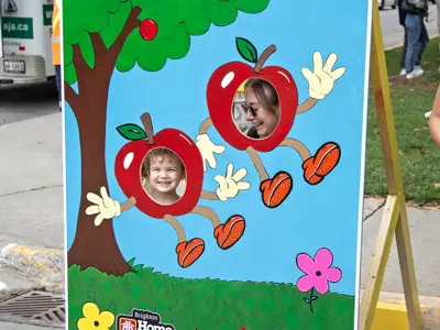 A child and woman pose in a photo mural.
