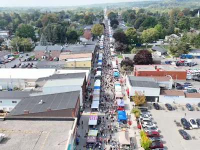 Drone photo of Main Street with hundreds of vendors lining the street.